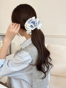 Close-up of blue striped layered scrunchie on a ponytail for women's hairstyle