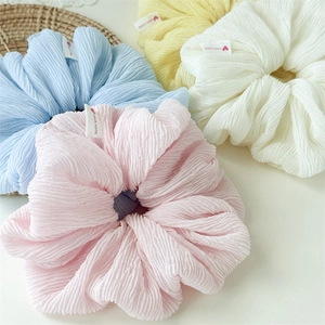 Set of four pastel bubble scrunchies in pink, blue, white, and yellow for women