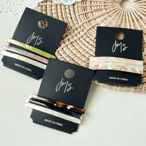Set of three acetate bobby pins with marble and tortoiseshell patterns on card