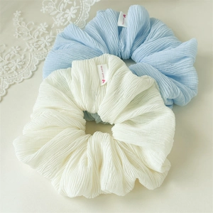 Handmade puffy pleated scrunchies in light blue and beige with heart woven label
