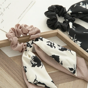 Elegant floral bow scrunchies with long ribbons in soft pink and black fabric