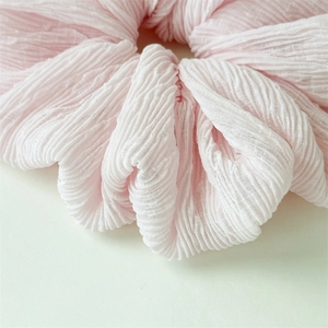 Detail of soft pink bubble fabric texture on a minimalist Korean style hair scrunchie