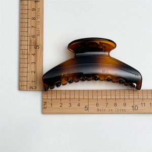 Detail showing 10.5cm large tortoiseshell hair claw clip with smooth glossy finish