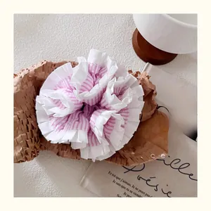Close-up of pink and white striped ruffle hair scrunchie with multi-layered design