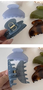 Detail of glossy fan-shaped hair claw clips showing translucent colors and metal spring