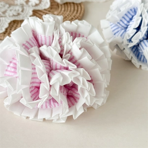 Korean style blue and pink striped ruffled scrunchies set for women on beige background