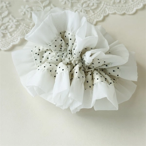 Detailed view of layered white chiffon scrunchie with black polka dots and lace trim