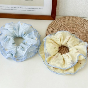 Close-up of floral scrunchies set with detailed pleated texture and fine stitching
