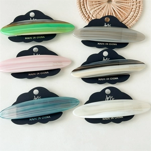 Detailed set of six marble-patterned acetate hair clips in varied colors on display card