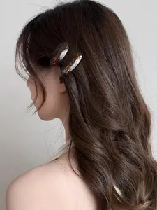 Detail of tortoise shell acetate hair clips with handmade France lettering on hair