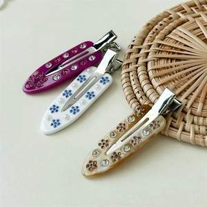 Three-piece acetate hair clip set with marble patterns and sparkling floral rhinestones