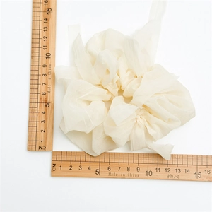 Detailed view of cream-colored oversized puff scrunchie measuring 15cm with soft organza fabric