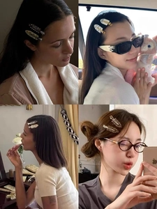 Detail showing acetate flower hair clips with marble patterns and rhinestones on hair