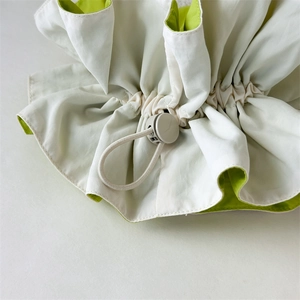 Dual-layer scrunchie hair tie in beige and neon yellow with adjustable drawstring toggle