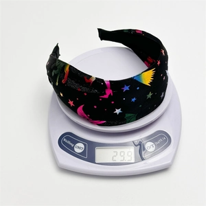 Detailed view showing the 29.9g lightweight fabric headband on a digital scale