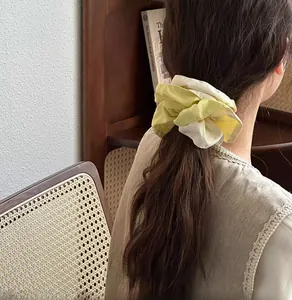 Close-up of yellow and beige drawstring scrunchie on a ponytail for hair styling