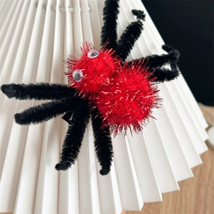 Détail d'une pince à cheveux araignée rouge pailletée avec pattes en peluche Halloween