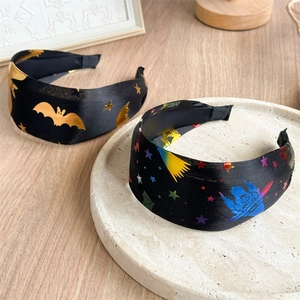 Wide Halloween headband set with golden stars and bat patterns on black satin fabric
