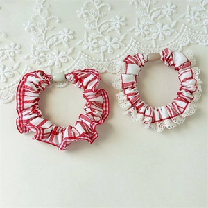 Detail showing red and white striped hair scrunchies with elegant lace trim and plastic button