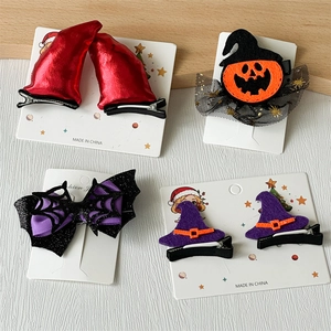 Halloween hair clips set featuring pumpkin, devil horns, and spider web on a display card
