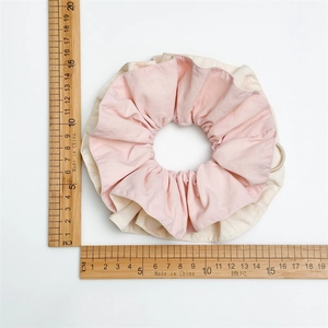 Detail shot showing 16cm oversized pink and beige layered fabric scrunchie with ruler measurements