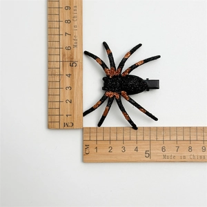 Glittery spider hair clip for Halloween costumes with measuring ruler for size reference