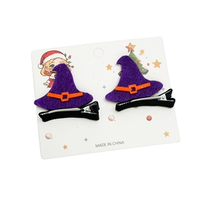 Detailed pair of purple felt witch hat hair clips with orange buckle on holiday card