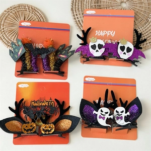 Set of four Halloween themed hair clips featuring pumpkins, ghosts, and bats in festive colors