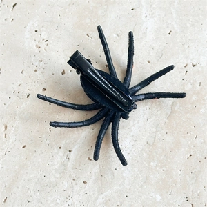 Detail view of black glitter spider hair clip with metal duckbill back for Halloween