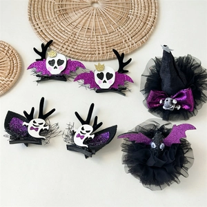Detailed flat lay of Halloween hair clips with skull crowns, ghosts, and purple bats