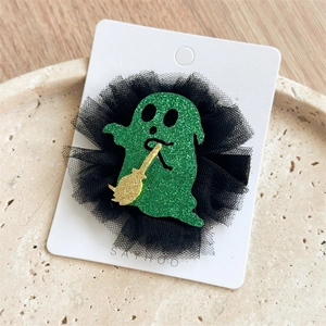 Détail de la pince à cheveux fantôme scintillante avec balai doré et tulle noir