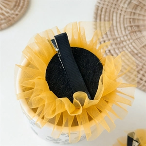 Detail view of sunflower hair clip back with black felt base and wrapped metal crocodile clip