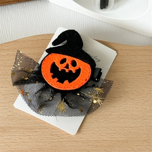 Detail of Halloween pumpkin hair clip with wizard hat, black mesh, and gold sequins