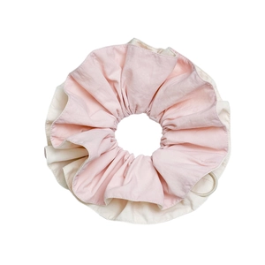 Dual-layer scrunchie in yellow and beige fabric with a stylish drawstring design