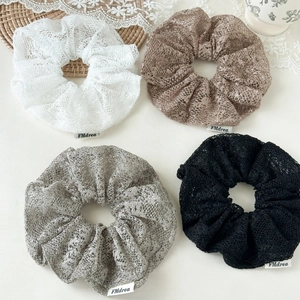 Detailed set of four lace scrunchies in white, beige, gray, and black colors