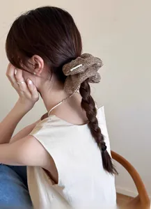 Detail of champagne mesh hair scrunchie with metallic finish on a ponytail