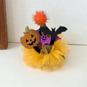 Detail of Halloween hair clip featuring glitter pumpkin, sequins bats and yellow mesh lace