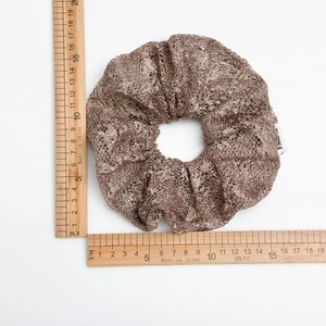Detail view of a champagne mesh scrunchie measured at 11cm diameter on a white background