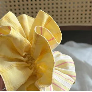 Chic yellow and pink striped scrunchie with layered ruffles and textured fabric