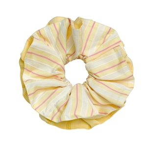 Fashionable yellow and white striped fabric scrunchie with soft ribbed texture