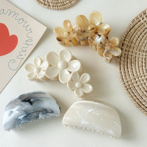 Set of four acetic acid hair clips featuring floral and geometric patterns in neutral tones
