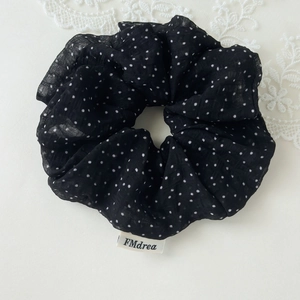 Detail of black polka dot oversized scrunchie in lightweight chiffon fabric