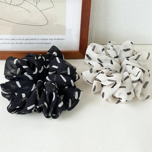 Set of black and beige striped organza oversized scrunchies with abstract line patterns