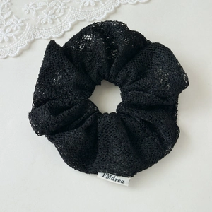 Elegant black lace scrunchie for women, high-quality hair tie with brand label detail