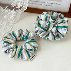 Set of two colorful striped knitted scrunchies with soft ribbed texture for hair