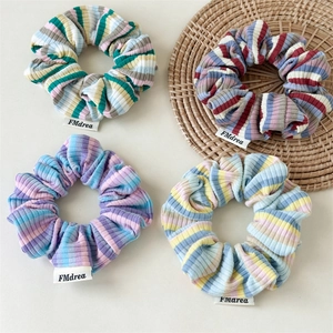 Set of four colorful striped ribbed knit hair scrunchies in dopamine-inspired vibrant tones