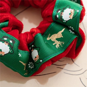 Detailed macro shot of red velvet Christmas scrunchie with festive reindeer ribbon patterns