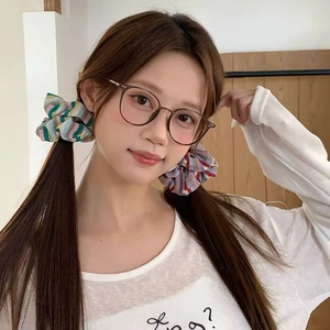 Detail view of colorful striped knit scrunchies used for twin pigtails hairstyle