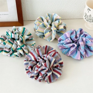 Set of four colorful striped ribbed fabric scrunchies for elegant ponytail styling