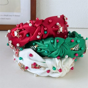 Christmas knot headbands set with pearls and festive charms on satin fabric